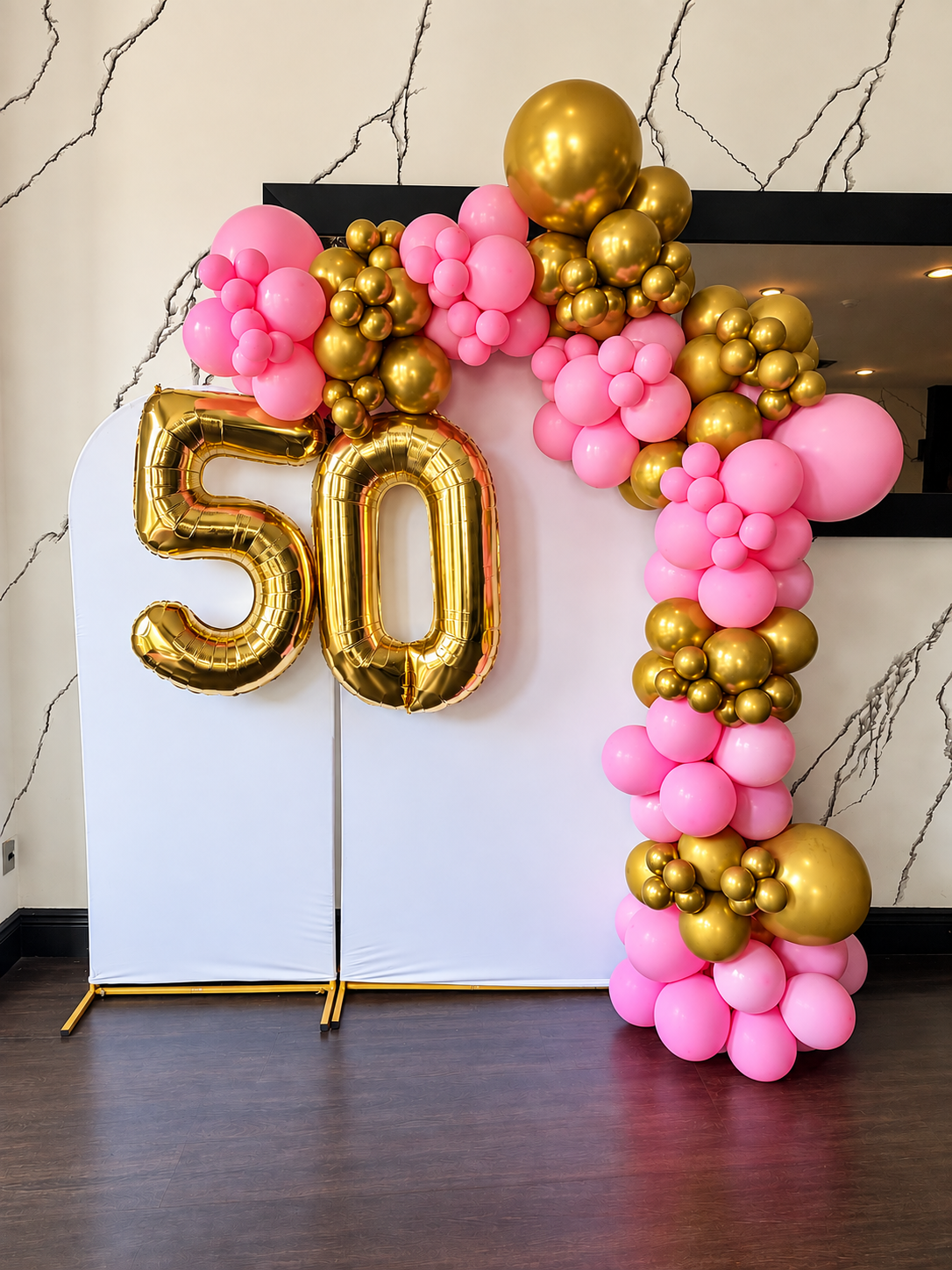 Pink and gold 50th birthday balloon garland and backdrop by SobyCam Event Services